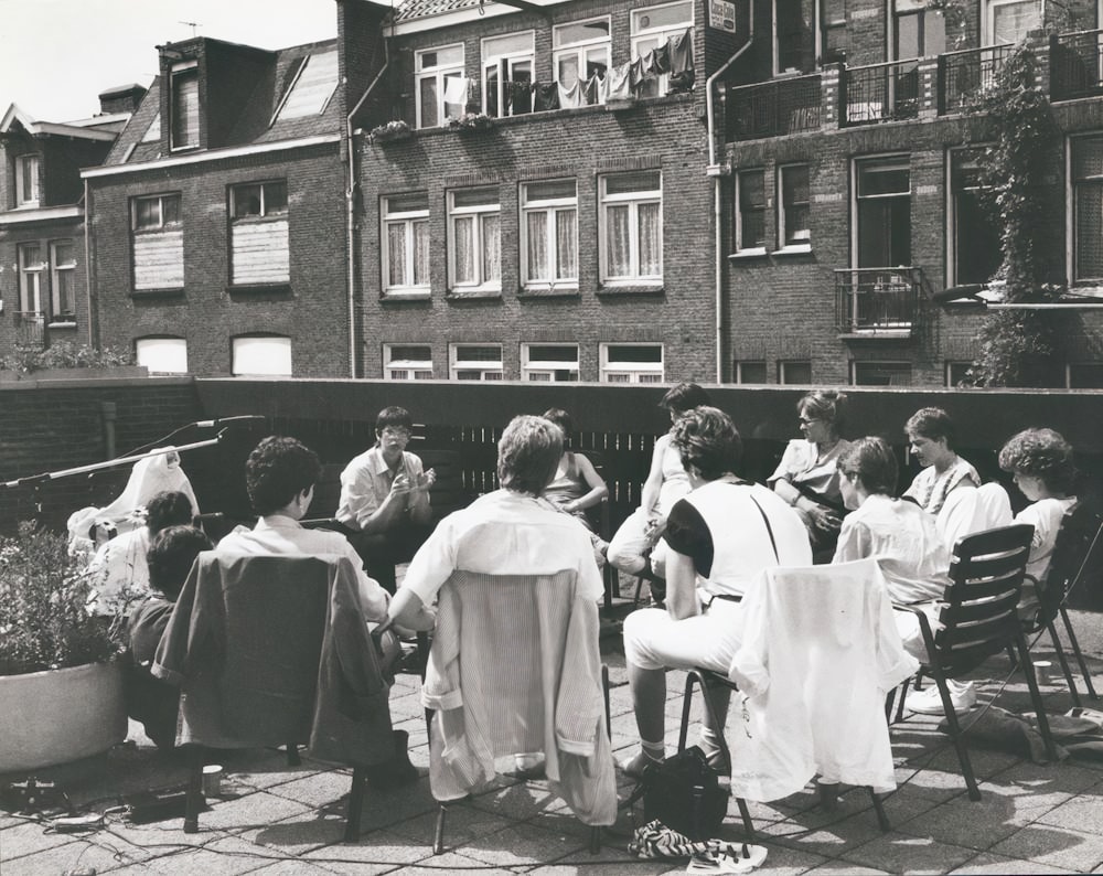 a group of people sitting at a table outside