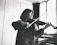 Happy young woman practicing violin at home with a warm sunlit background
