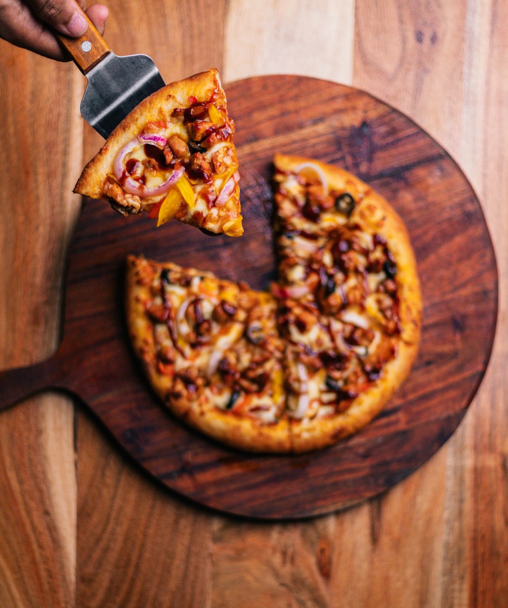 a pizza being cut