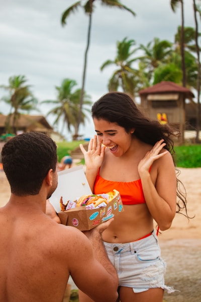 a man and woman eating popcorn