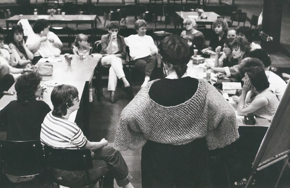 a group of people sitting at desks