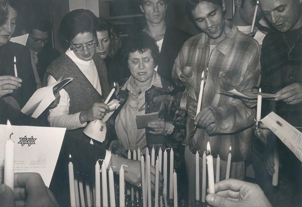 a group of people holding papers