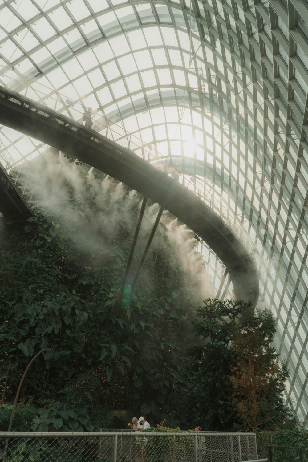 a large glass building with trees in front of it