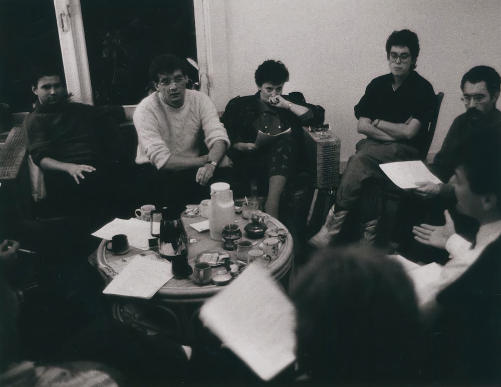 a group of people sitting around a table