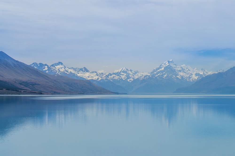 a body of water with mountains in the background with Aoraki / Mount Cook in the background