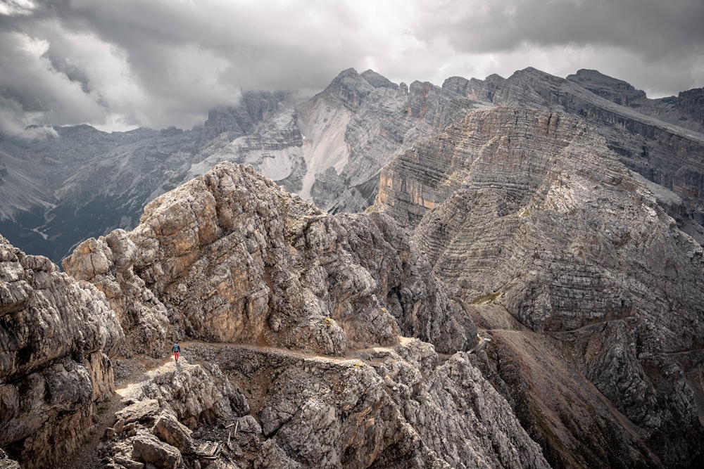 a person standing on a rocky mountain