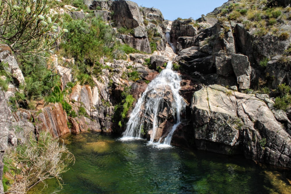 a waterfall over a body of water