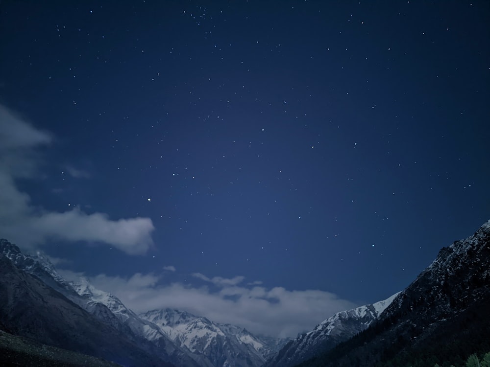 a mountain range with a starry sky above