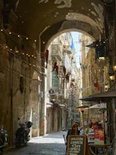 a narrow alleyway with shops