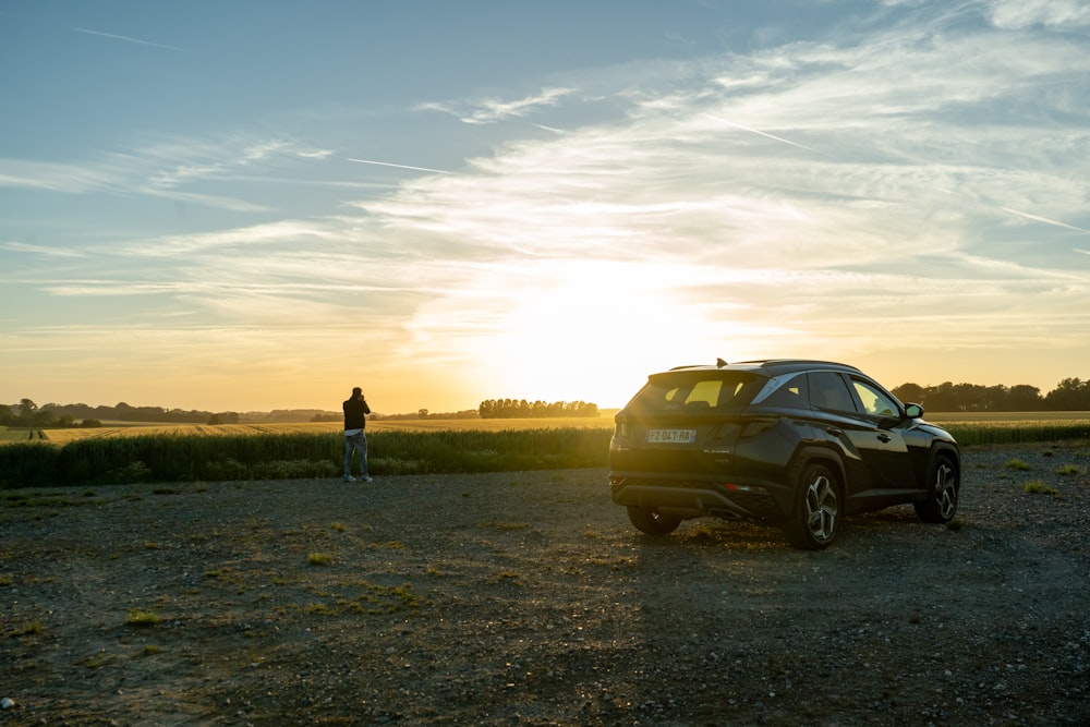 a man standing next to a car