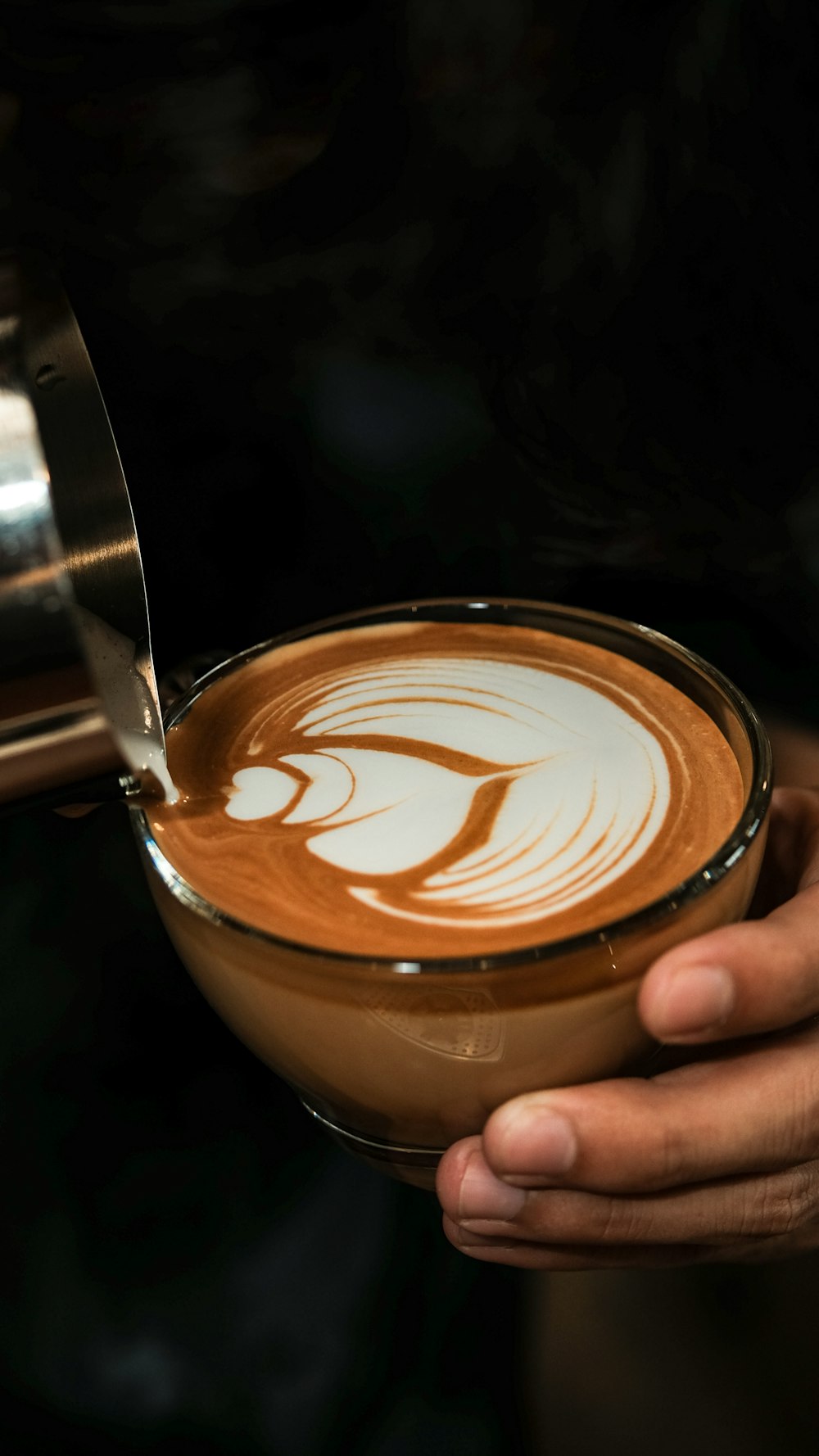 a person holding a cup of coffee