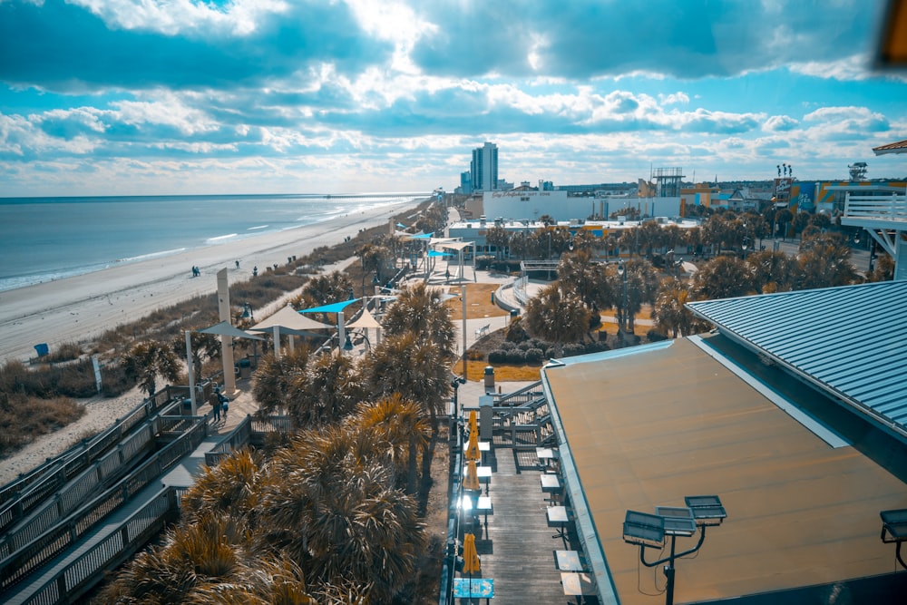 a beach with a body of water and buildings