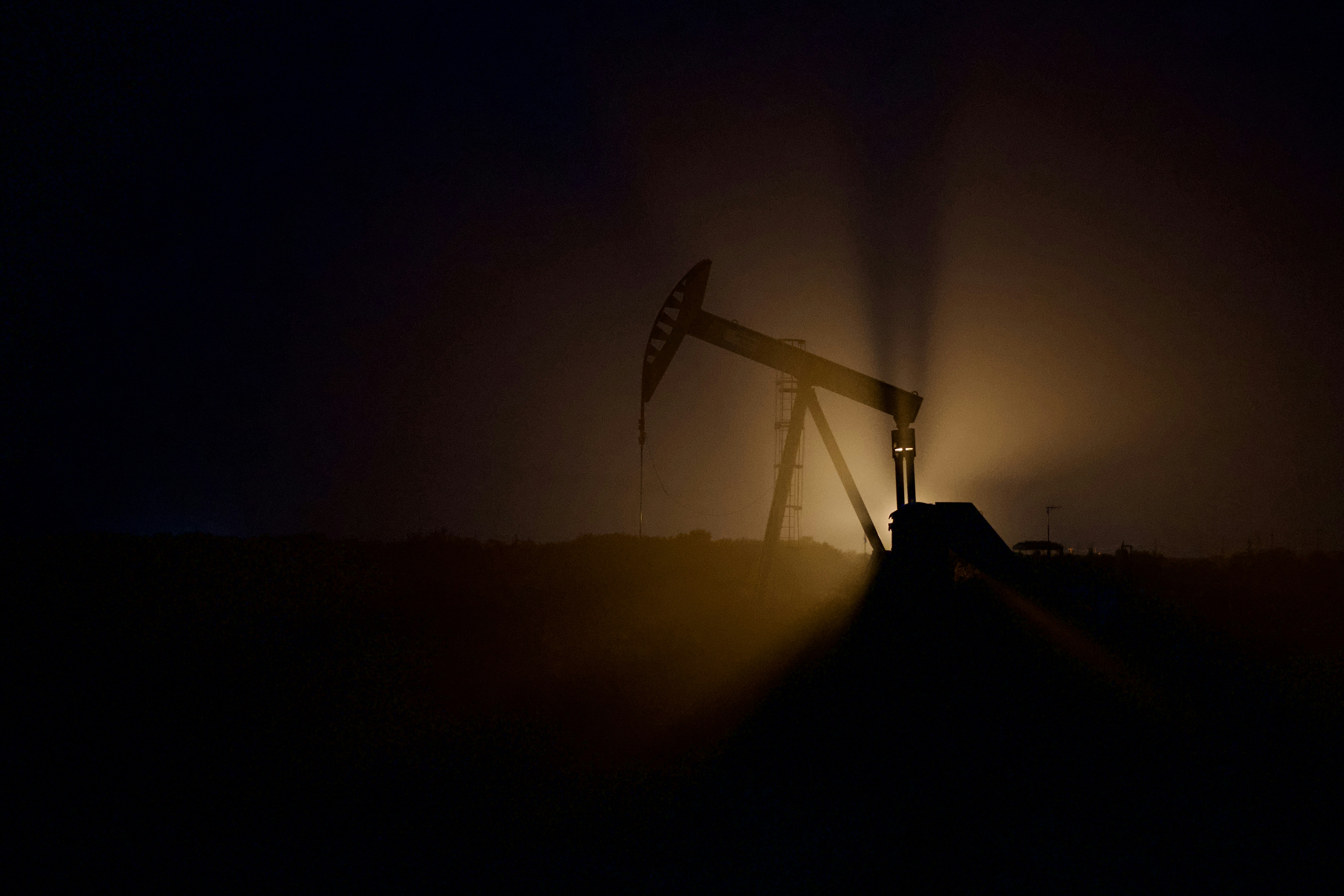 oil prices drop energy commodity - a crane at night