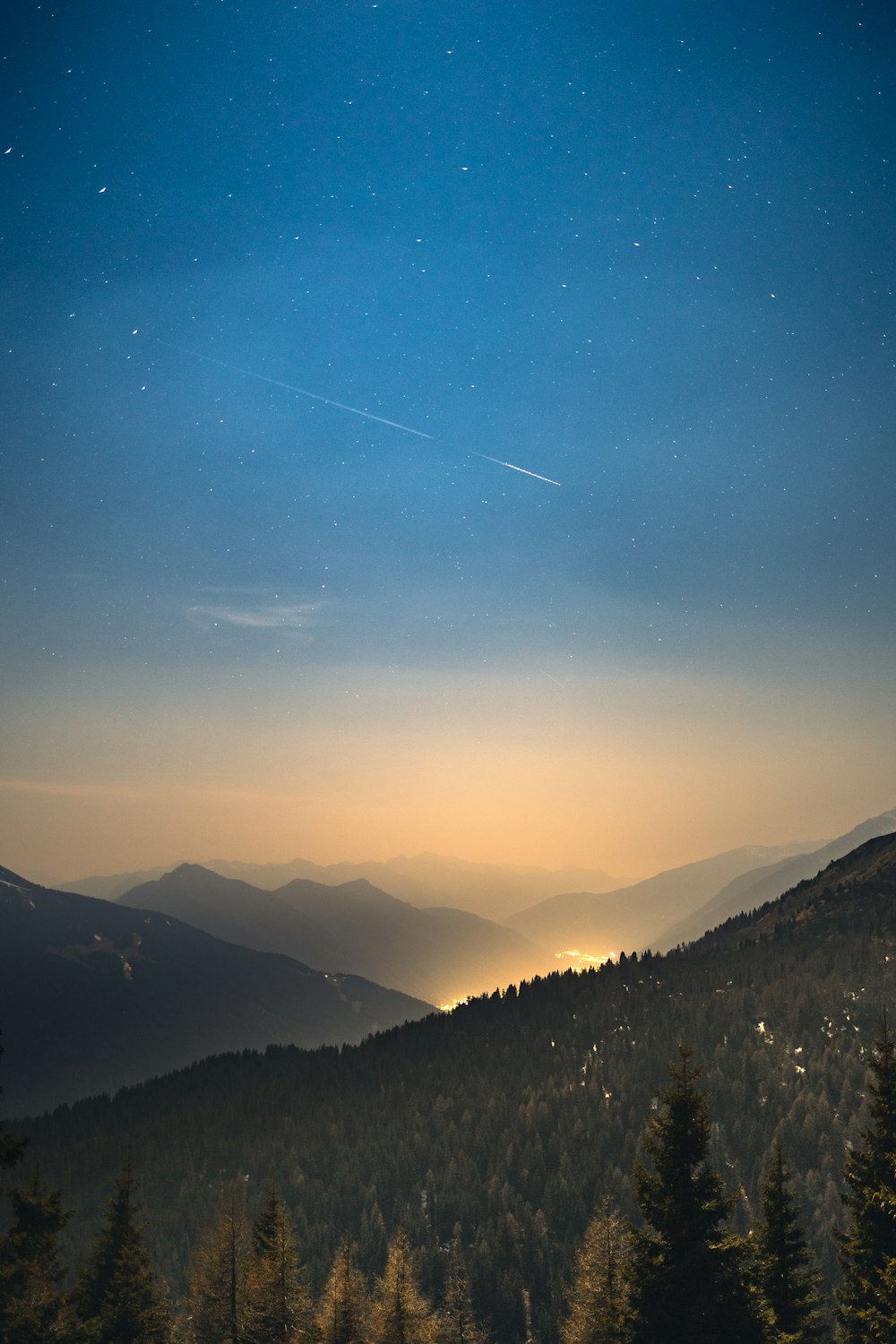 a landscape with trees and mountains