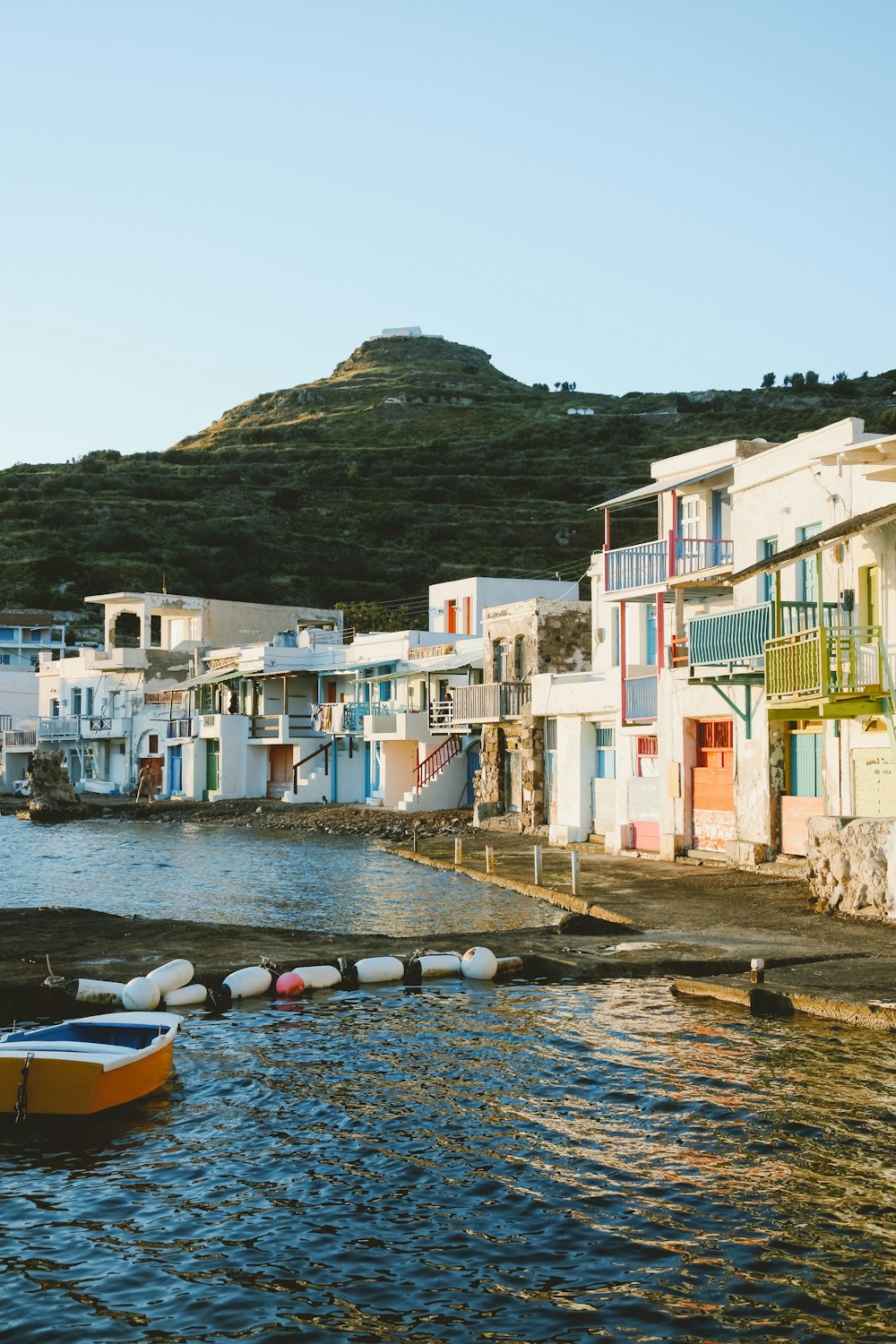 a row of colorful buildings next to a body of water