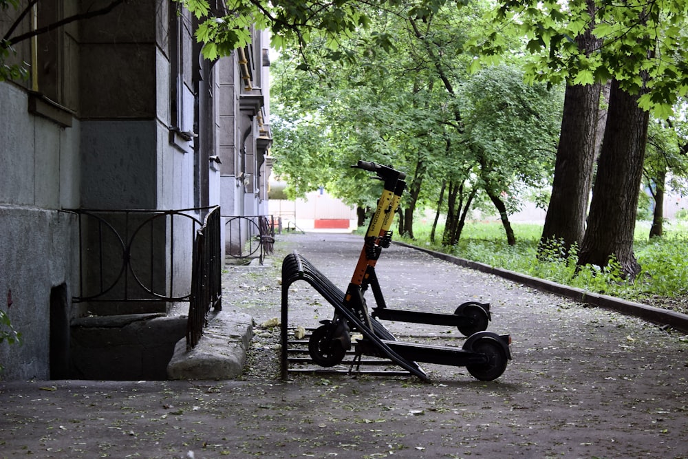 a scooter parked on a sidewalk