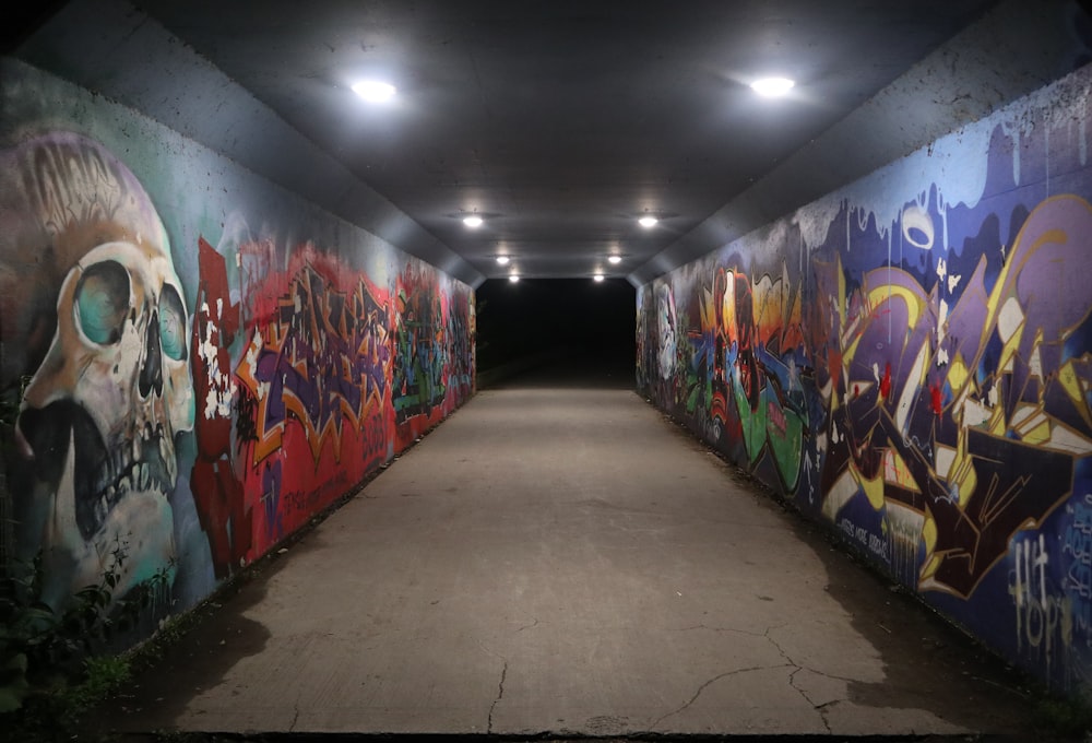 a tunnel with graffiti on the walls