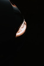 Close-up of a sleek car headlight upgrade glowing brightly at dusk.