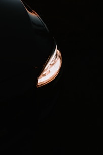 Close-up of a customized car with sleek LED headlights glowing at dusk.