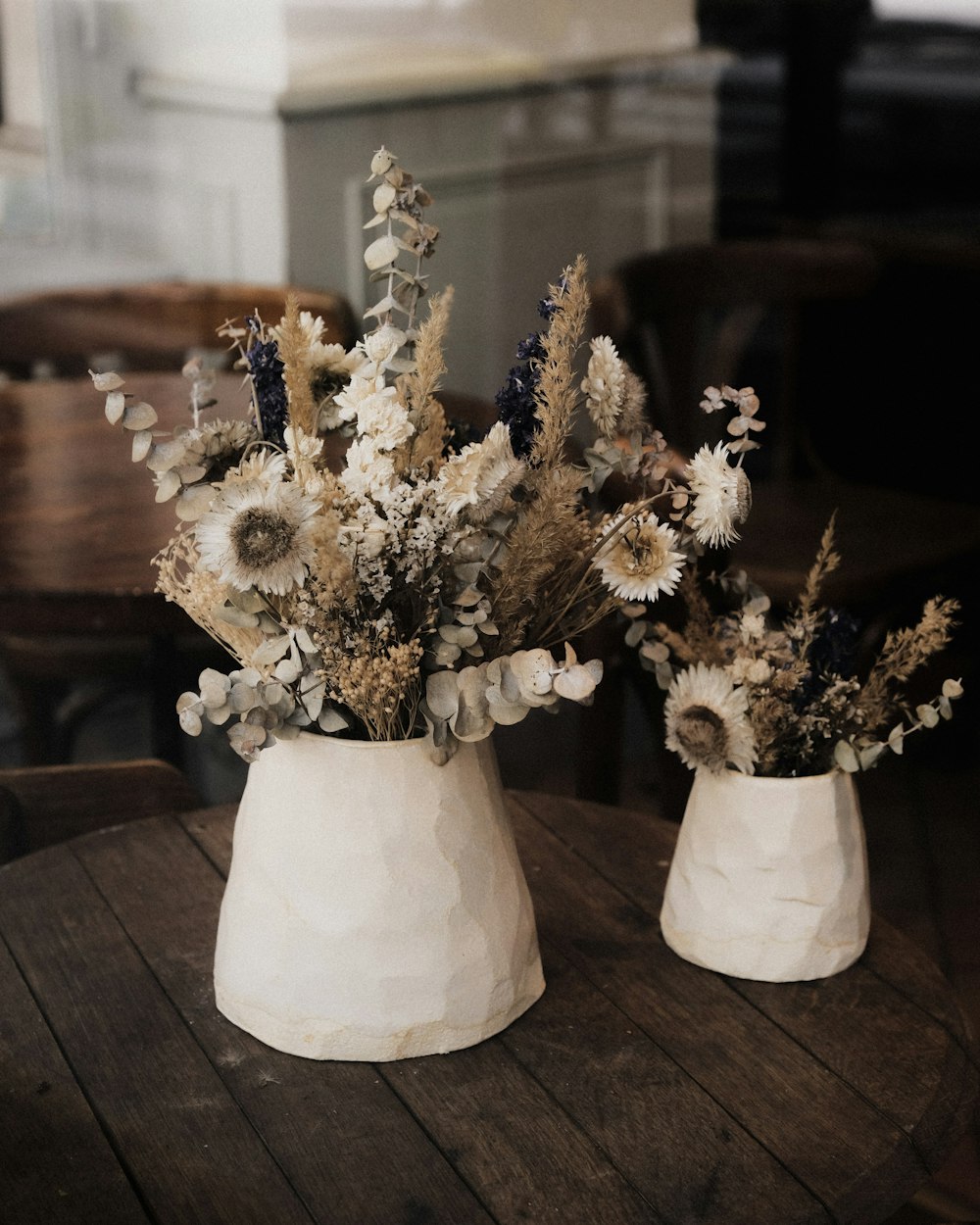 a couple of vases hold flowers