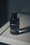 a black bottle of nail polish