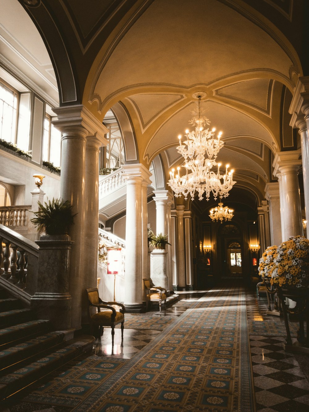 a large ornate room with a chandelier and chairs