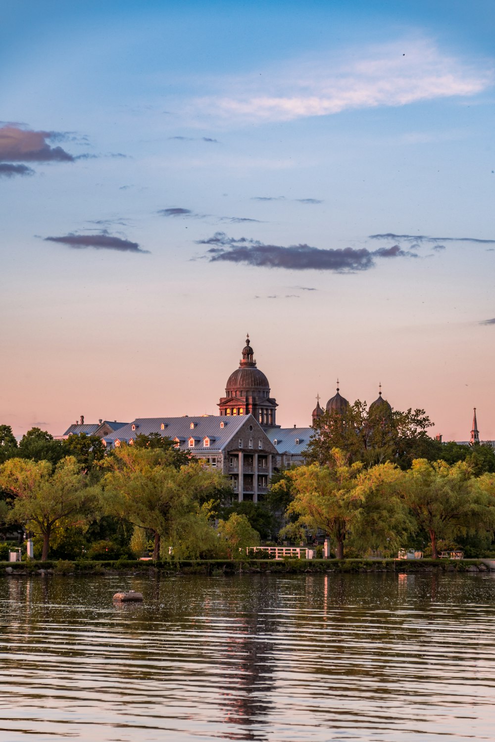 a building with a dome on top by a body of water