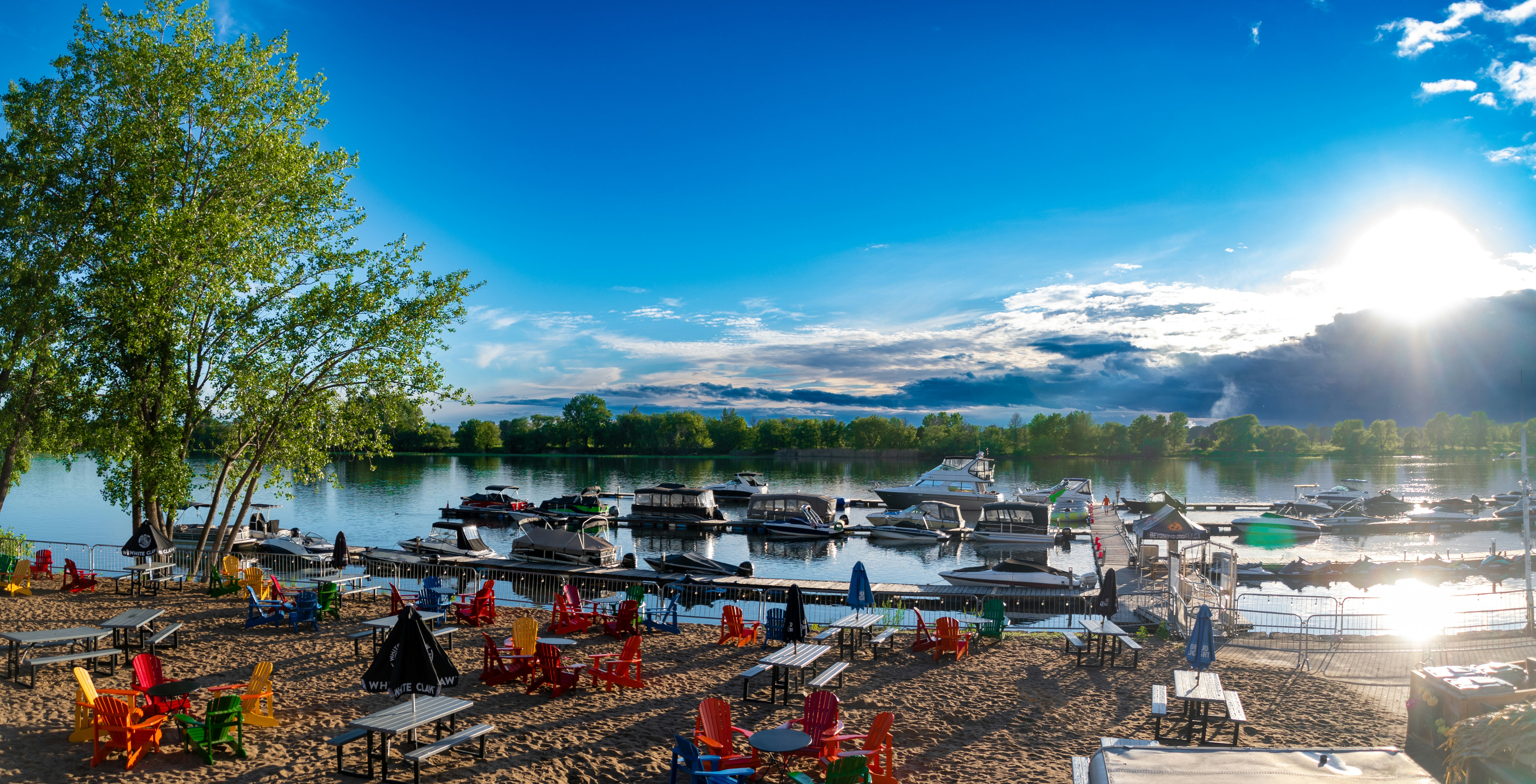 a beach with boats and chairs
