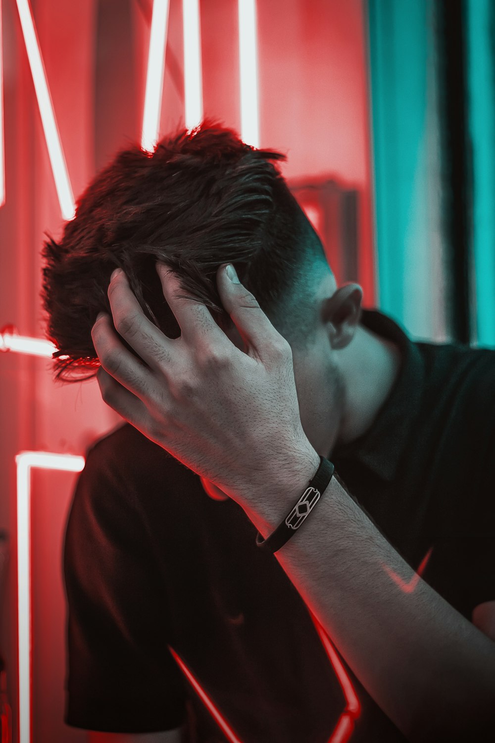 a man covering his face with his hand