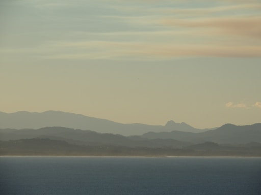a body of water with hills in the background
