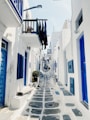 a narrow street with white buildings