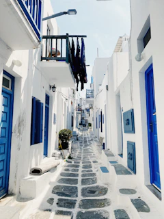 a narrow street with white buildings
