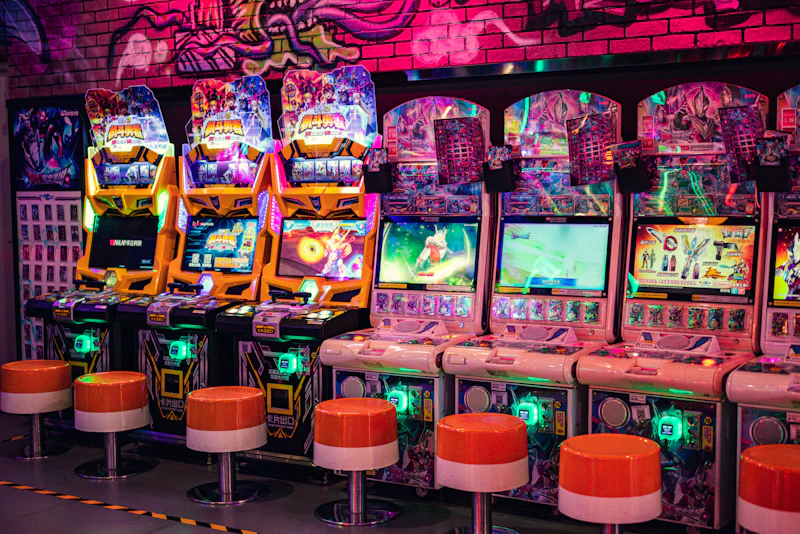 Rows of classic arcade cabinets illuminated by neon
