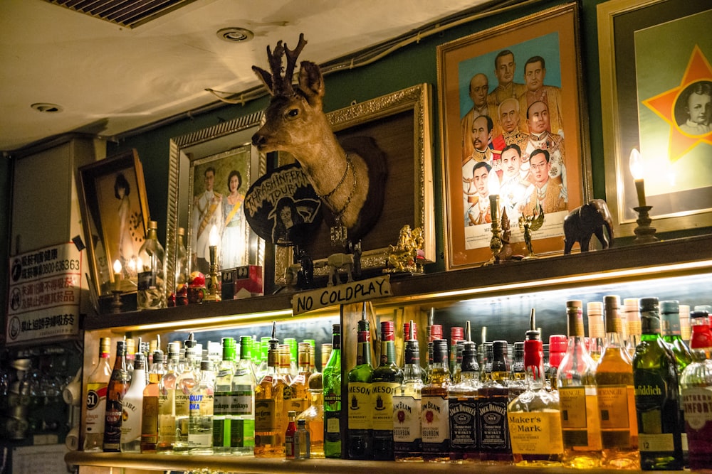 a wall with many bottles of alcohol on it