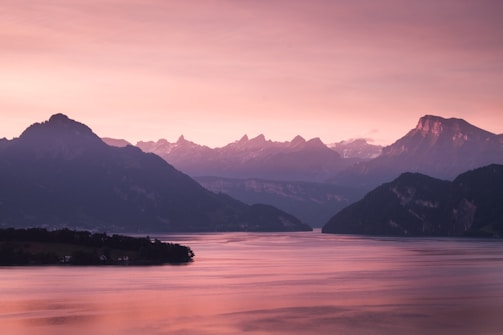 a body of water with mountains in the background