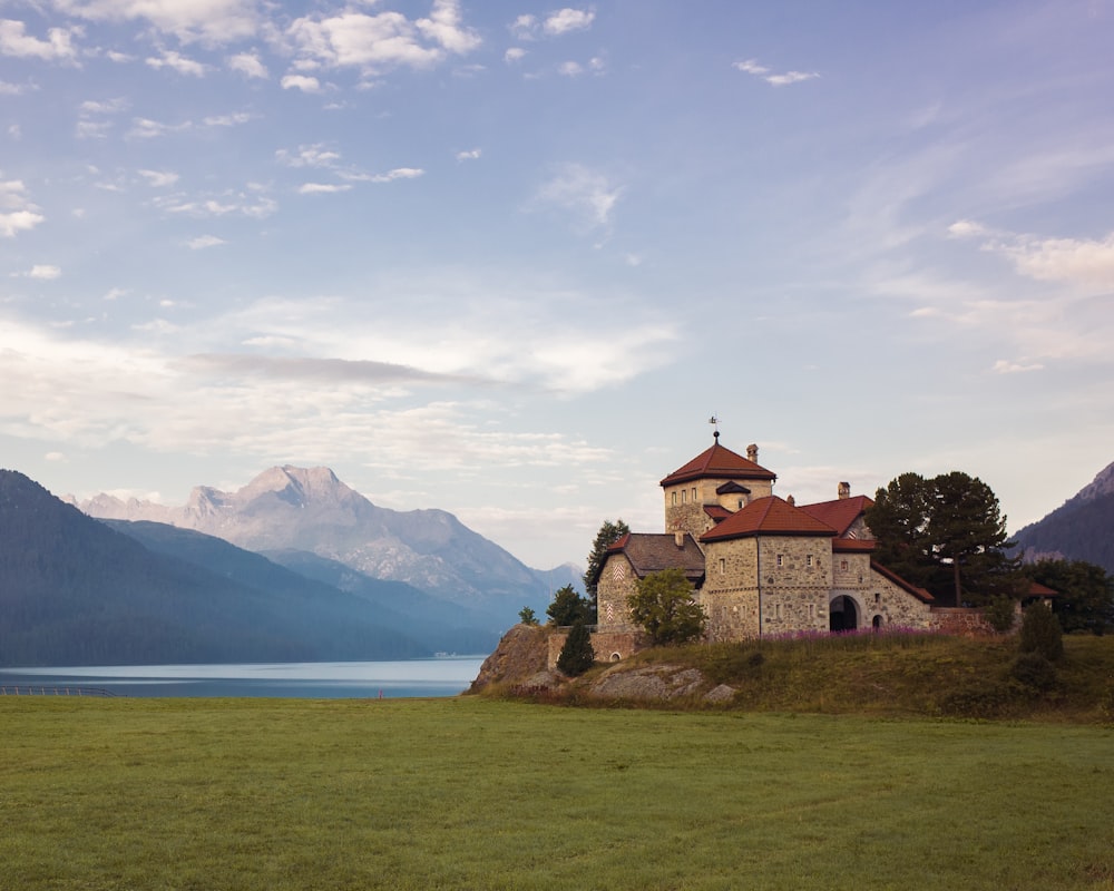 a building on a hill by the water