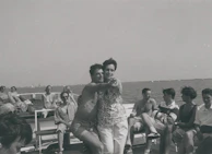 A candid moment of laughter and fun during a music and dance session on the yacht’s open deck.