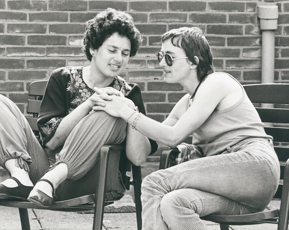 a couple of women sitting on a bench