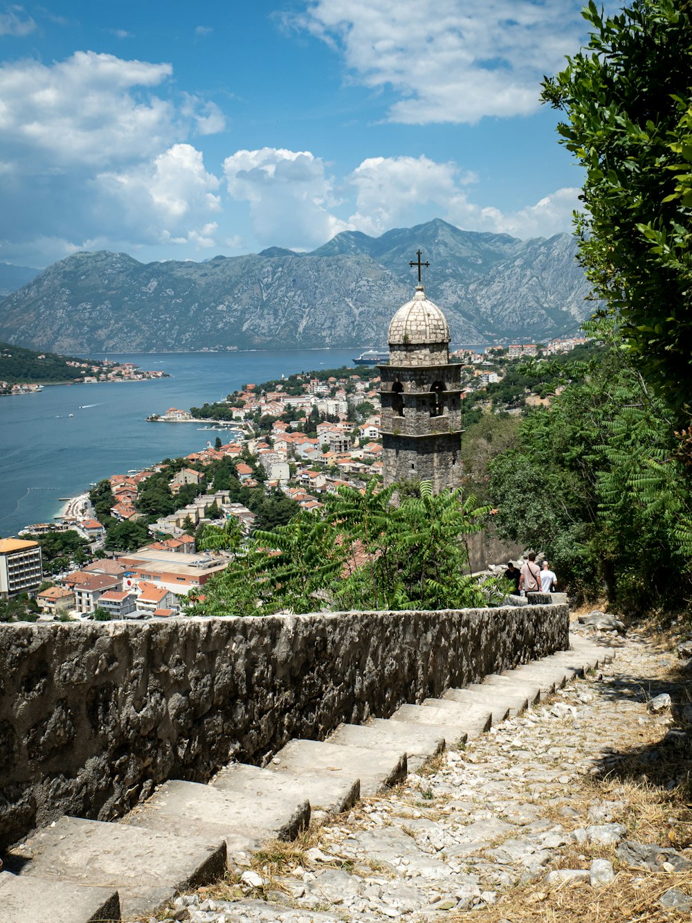 a city with a tower and a body of water in the background