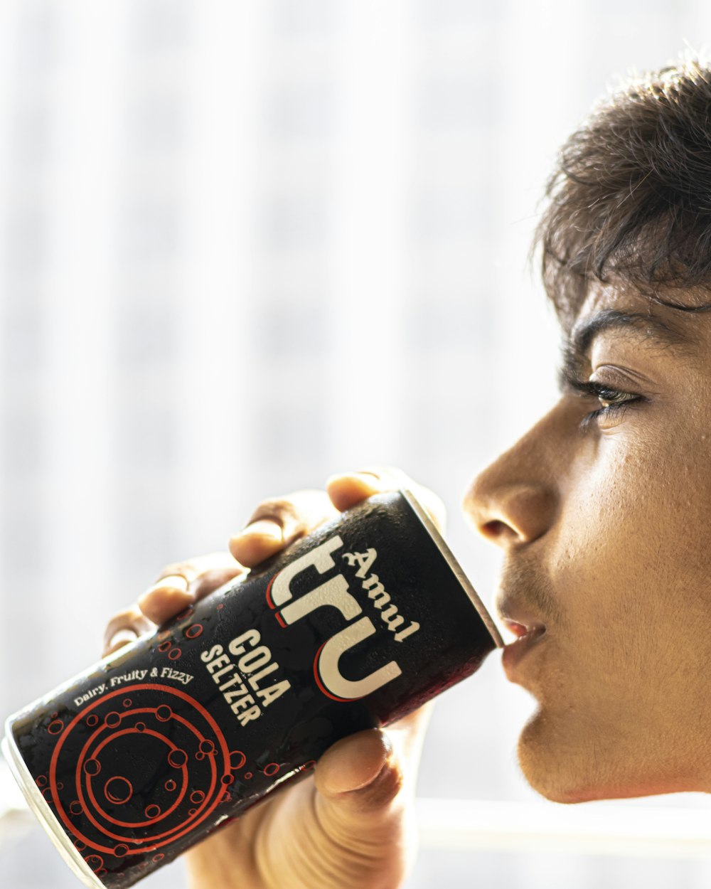 a man drinking from a can