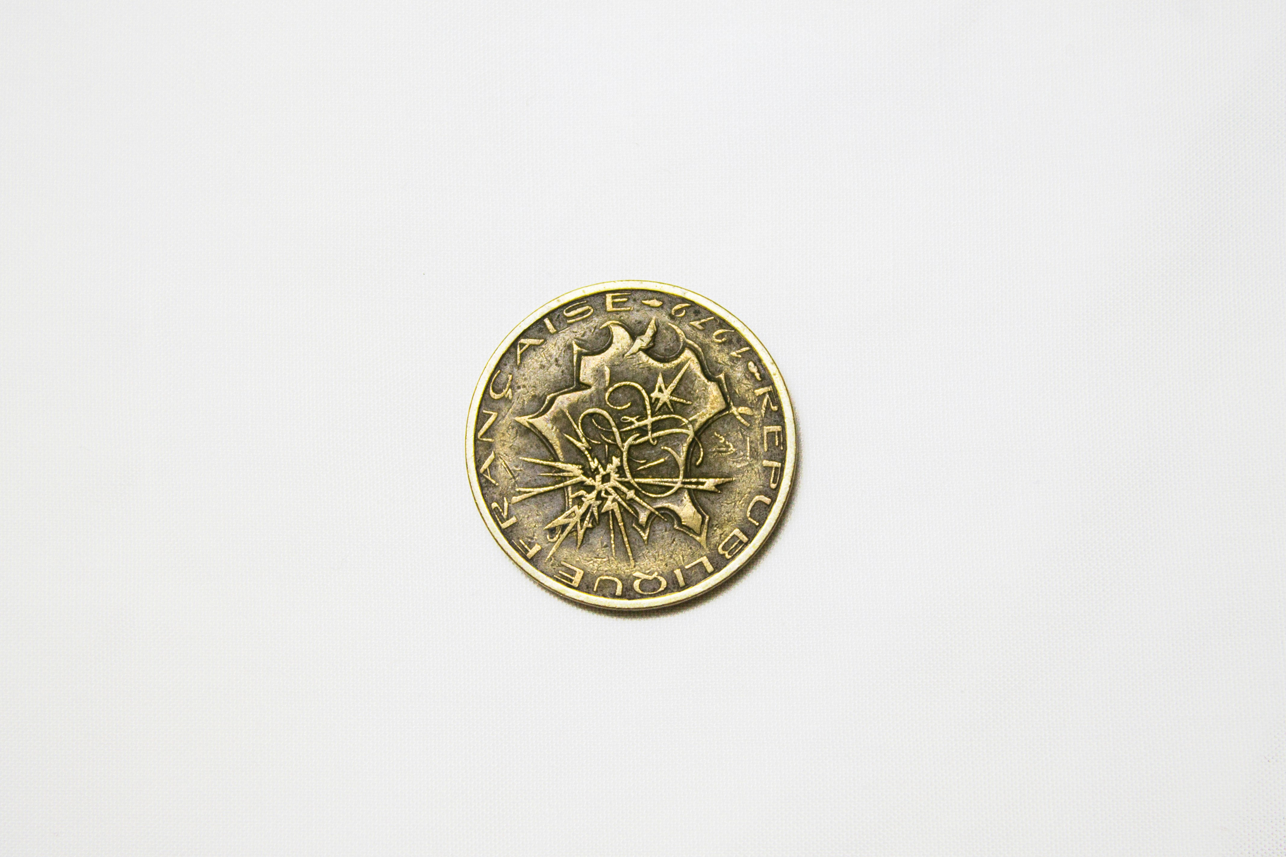 a gold coin with a design on it