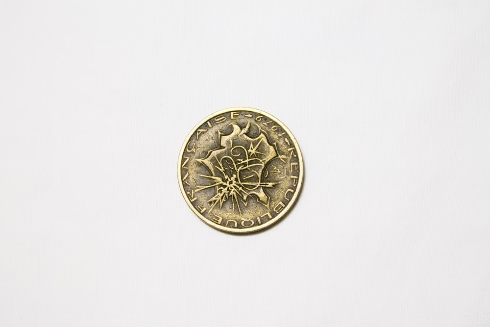 a gold coin with a design on it