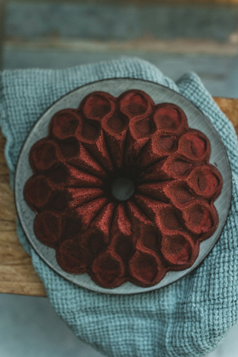 a red flower on a white and blue cloth