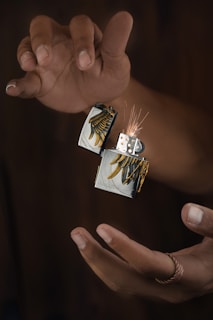a pair of hands holding a small card with a picture of a house