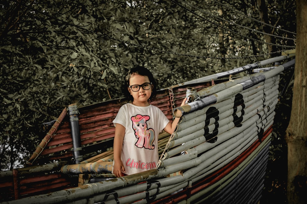 a boy standing in a boat