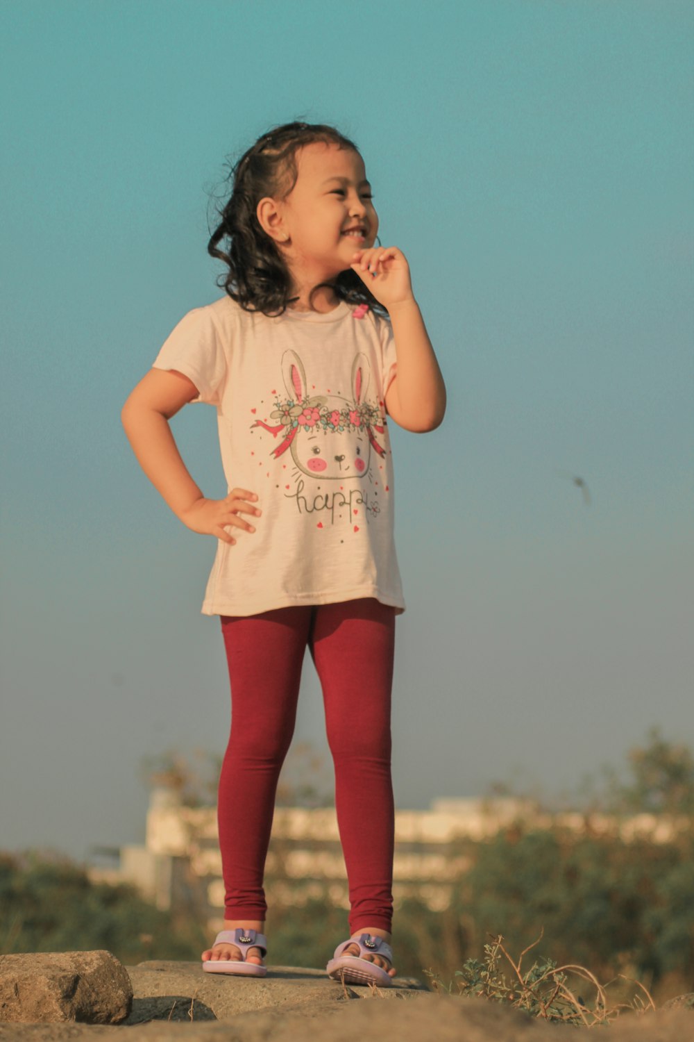 a girl standing on a rock