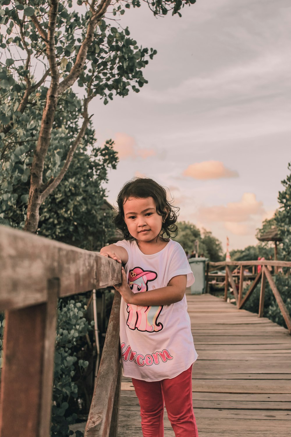 a girl standing on a bridge