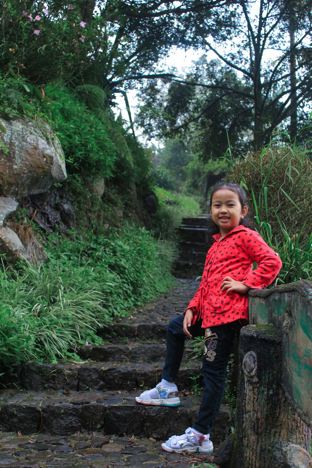 a girl sitting on a rock