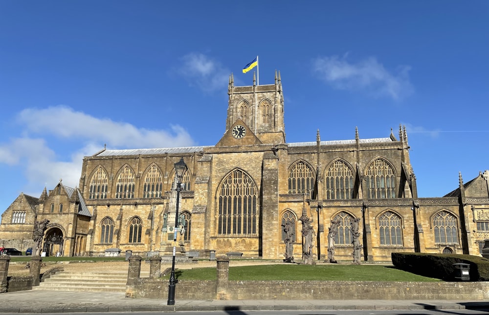 a large stone building with a flag on top