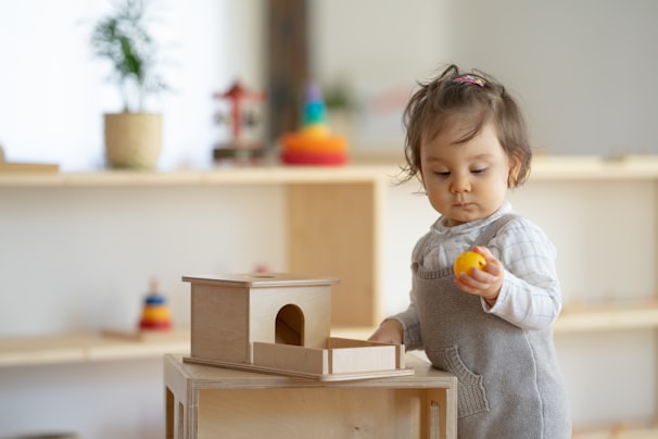 a little girl holding a yellow object